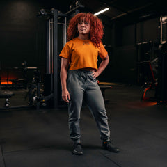 SBD Crop Top - Forge Limited Edition – oranje crop top gedragen met een grijze broek